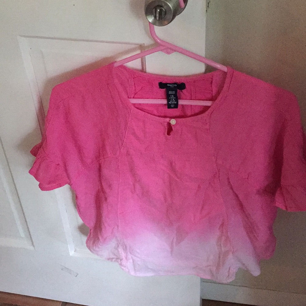 A girls pink to white ombré, lacy,flowy blouse.